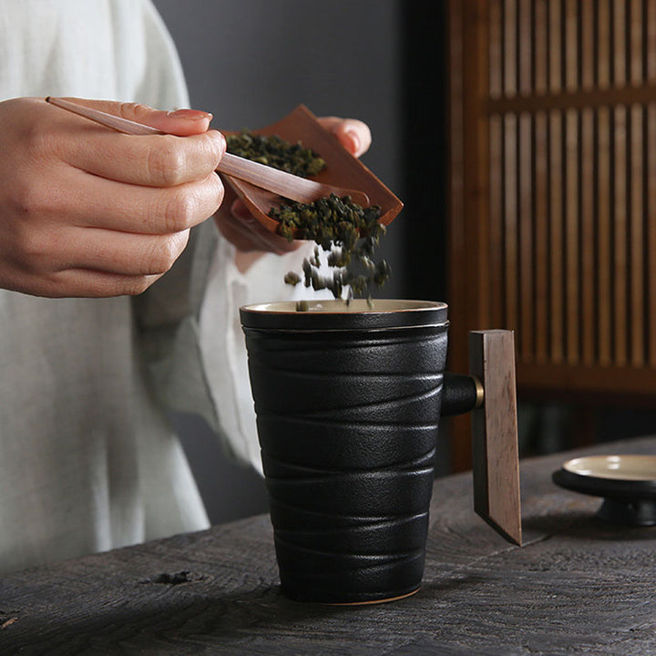 black pottery coffee and tea mug with wooden handle, reusable tea infuser