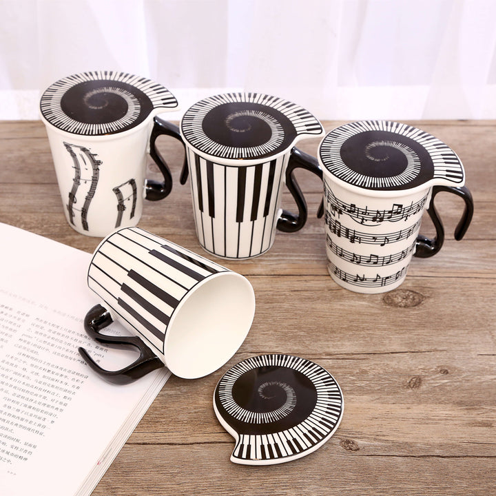 The coffee mug with musical note handle, piano keyboard as lid