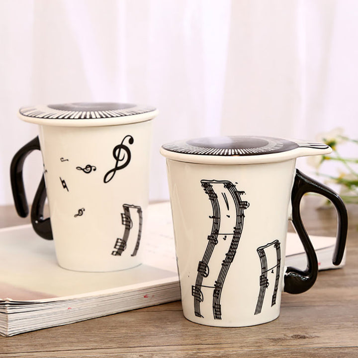 The coffee mug with musical note handle, piano keyboard as lid