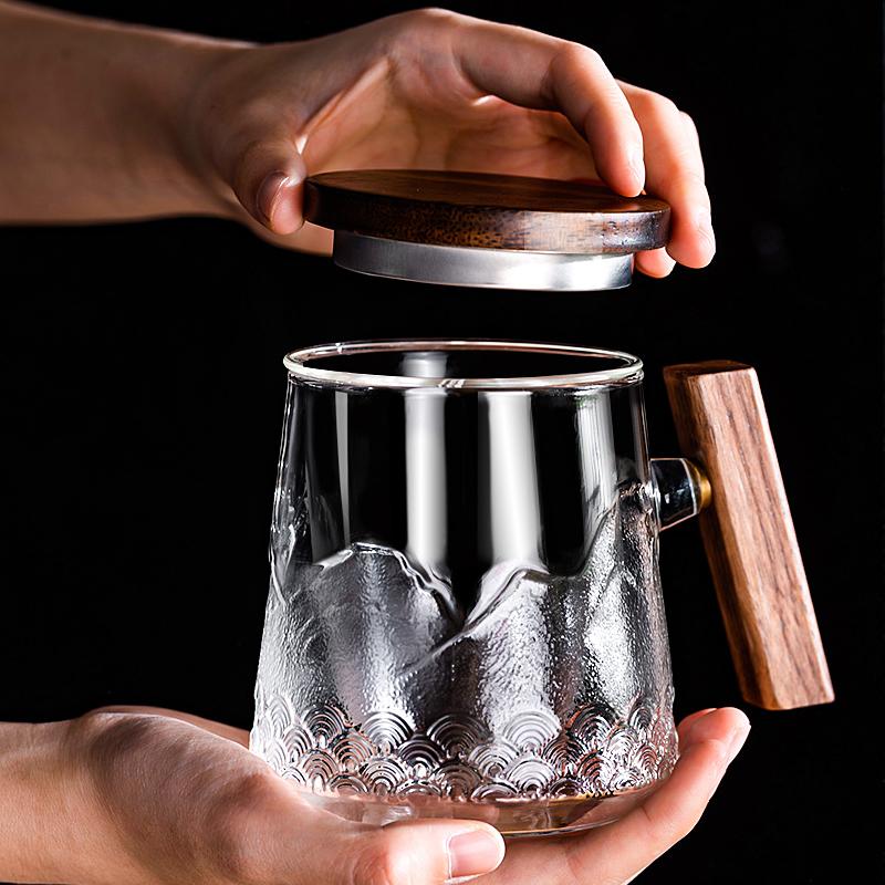 The glass coffee mug with wooden handle and lip