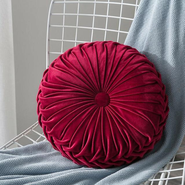 Coussin rond en velours capitonné